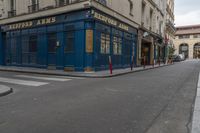 an empty street in the middle of paris with an apartment in the background that says hotel arts