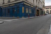 an empty street in the middle of paris with an apartment in the background that says hotel arts