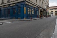 an empty street in the middle of paris with an apartment in the background that says hotel arts