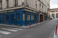 an empty street in the middle of paris with an apartment in the background that says hotel arts