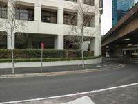 empty street, parking garage and road signs at a station intersection in a city setting