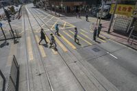 an empty street with several railroad tracks running through it to the right side of the picture