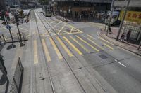 an empty street with several railroad tracks running through it to the right side of the picture