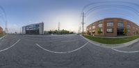 a large empty street with a building in the background and multiple road markings in white lines