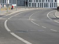 empty street with multiple signs on the side of the road in front of tall buildings