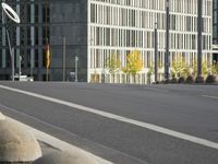 empty street with multiple signs on the side of the road in front of tall buildings
