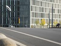 empty street with multiple signs on the side of the road in front of tall buildings