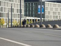 empty street with multiple signs on the side of the road in front of tall buildings