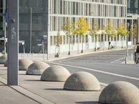 empty street with multiple signs on the side of the road in front of tall buildings