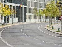 empty street with multiple signs on the side of the road in front of tall buildings
