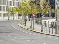 empty street with multiple signs on the side of the road in front of tall buildings