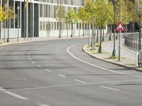 empty street with multiple signs on the side of the road in front of tall buildings