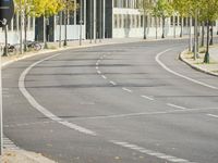 empty street with multiple signs on the side of the road in front of tall buildings