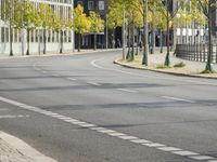 empty street with multiple signs on the side of the road in front of tall buildings