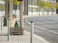 empty street with multiple signs on the side of the road in front of tall buildings