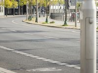 empty street with multiple signs on the side of the road in front of tall buildings