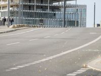 empty street with multiple signs on the side of the road in front of tall buildings