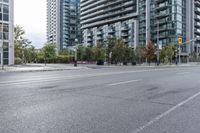 empty street with skyscrapers in the background and empty roads ahead on both sides of the picture
