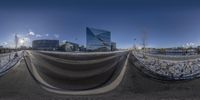 a fish eye view of an empty street in the snow and buildings are seen in the background