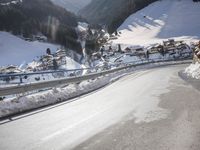an empty street is shown with no cars on it in the middle of the snowy mountain