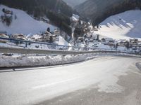 an empty street is shown with no cars on it in the middle of the snowy mountain