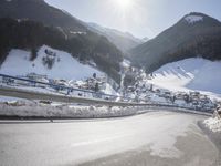 an empty street is shown with no cars on it in the middle of the snowy mountain
