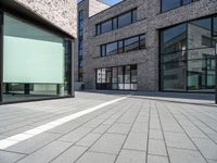 a empty street and window on a sunny day in the city area of the business district