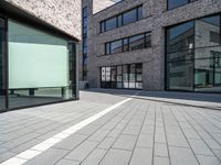 a empty street and window on a sunny day in the city area of the business district