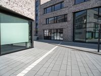 a empty street and window on a sunny day in the city area of the business district