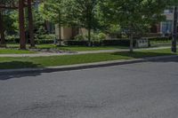 a stop sign is located in an empty street with trees and houses in the background