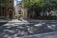 an empty street that leads to two old buildings on both sides and has a bench in front of the sidewalk