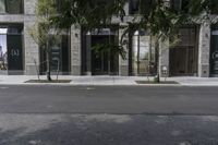 an empty street under a bridge that connects two buildings to the sidewalk and a sidewalk