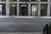 an empty street under a bridge that connects two buildings to the sidewalk and a sidewalk