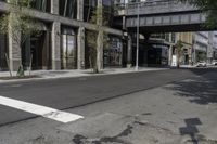 an empty street under a bridge that connects two buildings to the sidewalk and a sidewalk