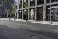 an empty street under a bridge that connects two buildings to the sidewalk and a sidewalk