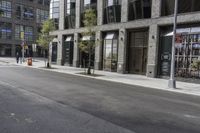 an empty street under a bridge that connects two buildings to the sidewalk and a sidewalk