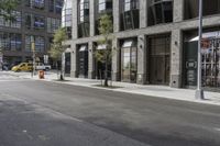 an empty street under a bridge that connects two buildings to the sidewalk and a sidewalk