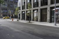 an empty street under a bridge that connects two buildings to the sidewalk and a sidewalk