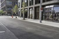 an empty street under a bridge that connects two buildings to the sidewalk and a sidewalk