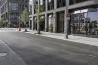 an empty street under a bridge that connects two buildings to the sidewalk and a sidewalk