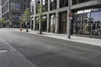 an empty street under a bridge that connects two buildings to the sidewalk and a sidewalk