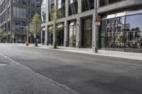 an empty street under a bridge that connects two buildings to the sidewalk and a sidewalk