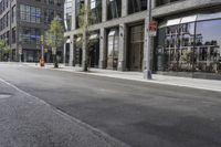 an empty street under a bridge that connects two buildings to the sidewalk and a sidewalk