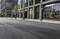 an empty street under a bridge that connects two buildings to the sidewalk and a sidewalk