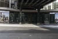 an empty street under a bridge that connects two buildings to the sidewalk and a sidewalk