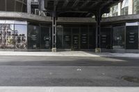 an empty street under a bridge that connects two buildings to the sidewalk and a sidewalk