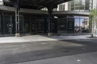 an empty street under a bridge that connects two buildings to the sidewalk and a sidewalk