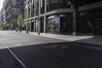 an empty street under a bridge that connects two buildings to the sidewalk and a sidewalk