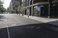 an empty street under a bridge that connects two buildings to the sidewalk and a sidewalk