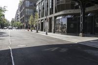 an empty street under a bridge that connects two buildings to the sidewalk and a sidewalk